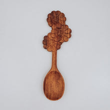 Load image into Gallery viewer, A wooden spoon with delicate flower carvings on the handle, designed for nature-themed play and adding beauty to every mix