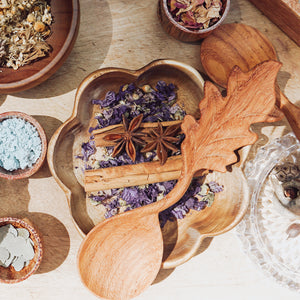 A larger wooden bowl carved in the shape of a flower, ideal for mixing potions or gathering natural treasures during outdoor play.