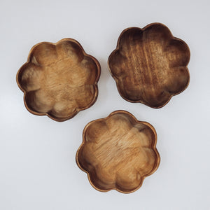 A larger wooden bowl carved in the shape of a flower, ideal for mixing potions or gathering natural treasures during outdoor play.