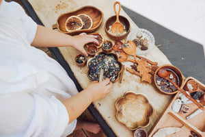 Eco-friendly outdoor play tools, including shovels, scoops, and bowls, all crafted with sustainability in mind for nature-inspired fun. Tuckered Out