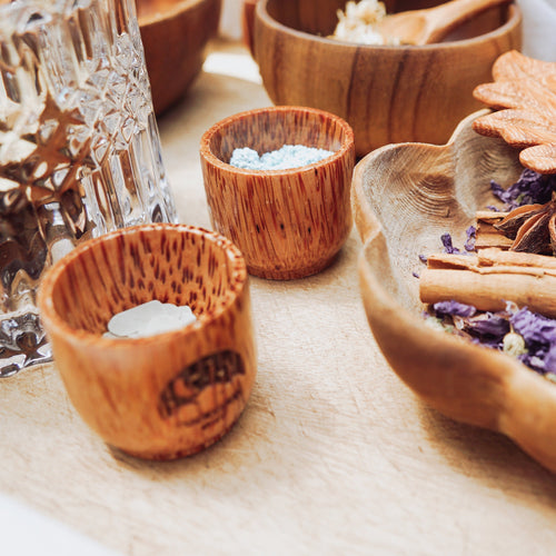 A small, handcrafted wooden bowl perfect for holding nature-inspired potion ingredients like dried botanicals and glitter