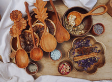 Load image into Gallery viewer, A large wooden spoon carved into a heart shape, perfect for mixing outdoor concoctions and adding a bit of charm to imaginative play.
